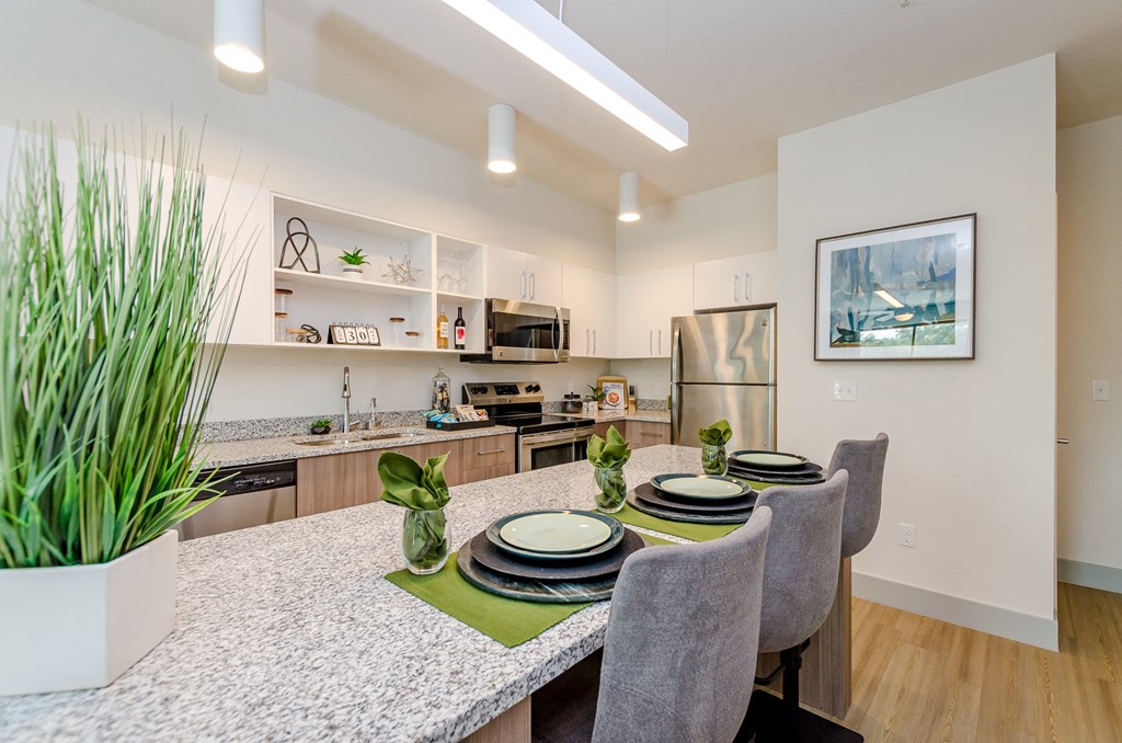 an open kitchen and dining area with a table and chairs at Lofts at South Lake, Florida, 34711