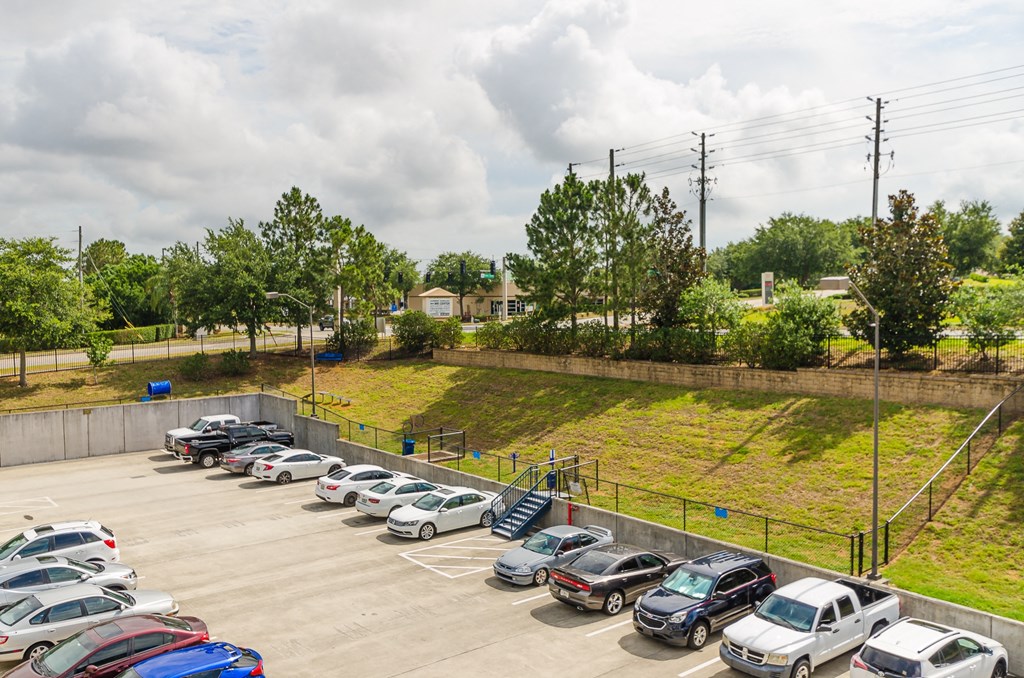 a parking lot with many cars parked in it at Lofts at South Lake, Clermont