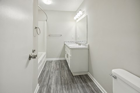 an empty bathroom with a sink and a mirror