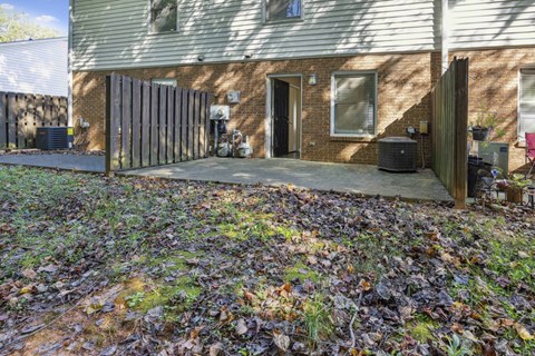 A house with a brown fence and a brown door.