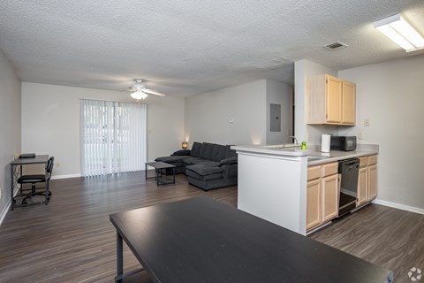 A kitchen with a table and a couch in the living room.