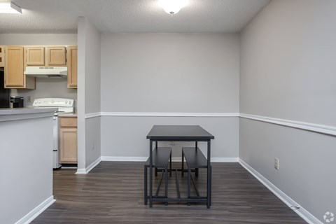 A kitchen with a table and chairs in the middle of the room.