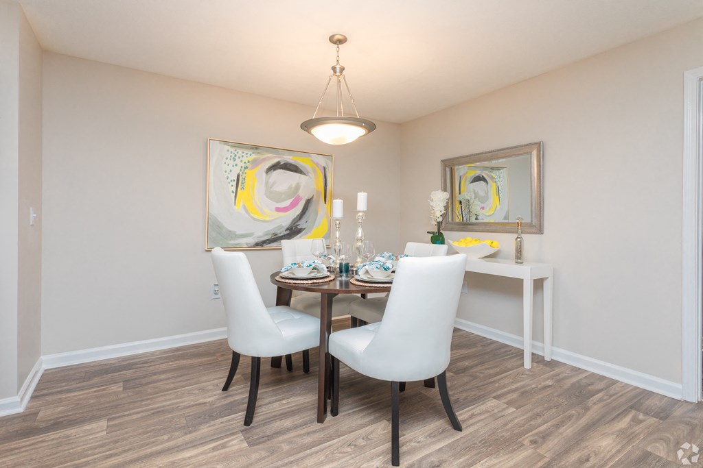 a dining room with a table and chairs