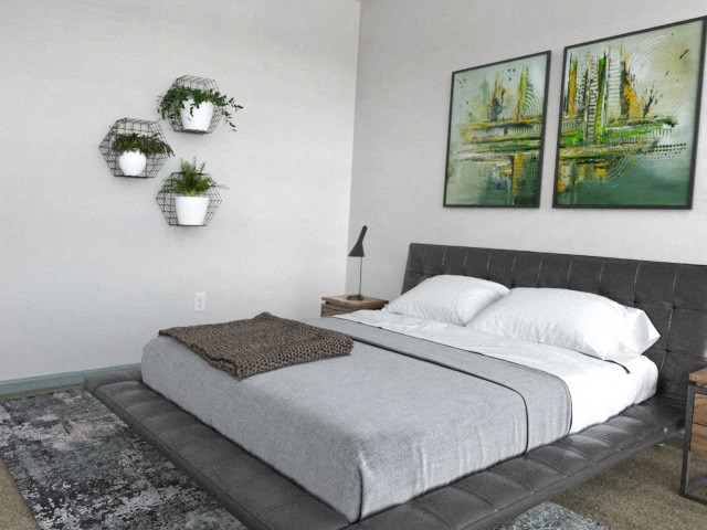 a bedroom with a bed and pictures on the wall