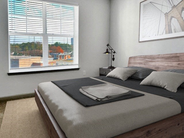 a bedroom with a large bed and a window