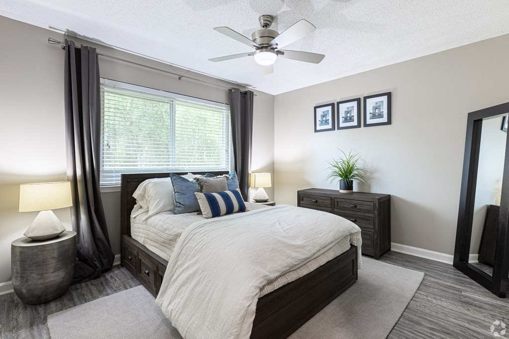 a bedroom with a bed and a ceiling fan