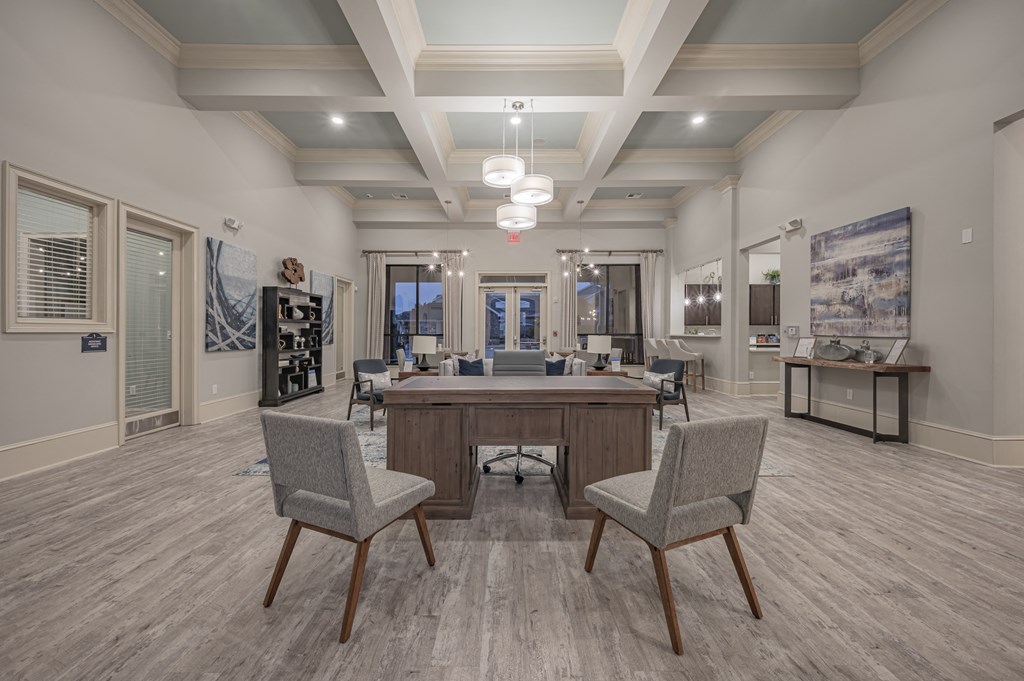 a clubhouse with a large table and chairs in the center of it at Century HomePlace, Prattville