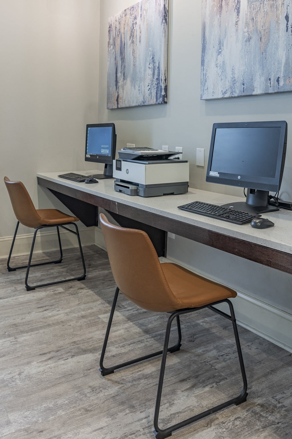 a computer desk with two monitors and two chairs at Century HomePlace, Prattville, AL 36066