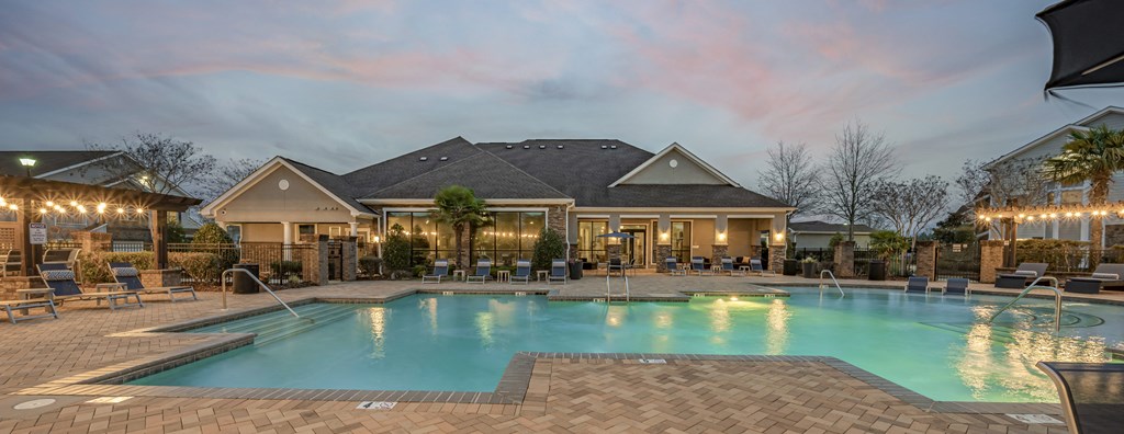 a swimming pool with chairs and a house with a pool at Century HomePlace, Alabama, 36066