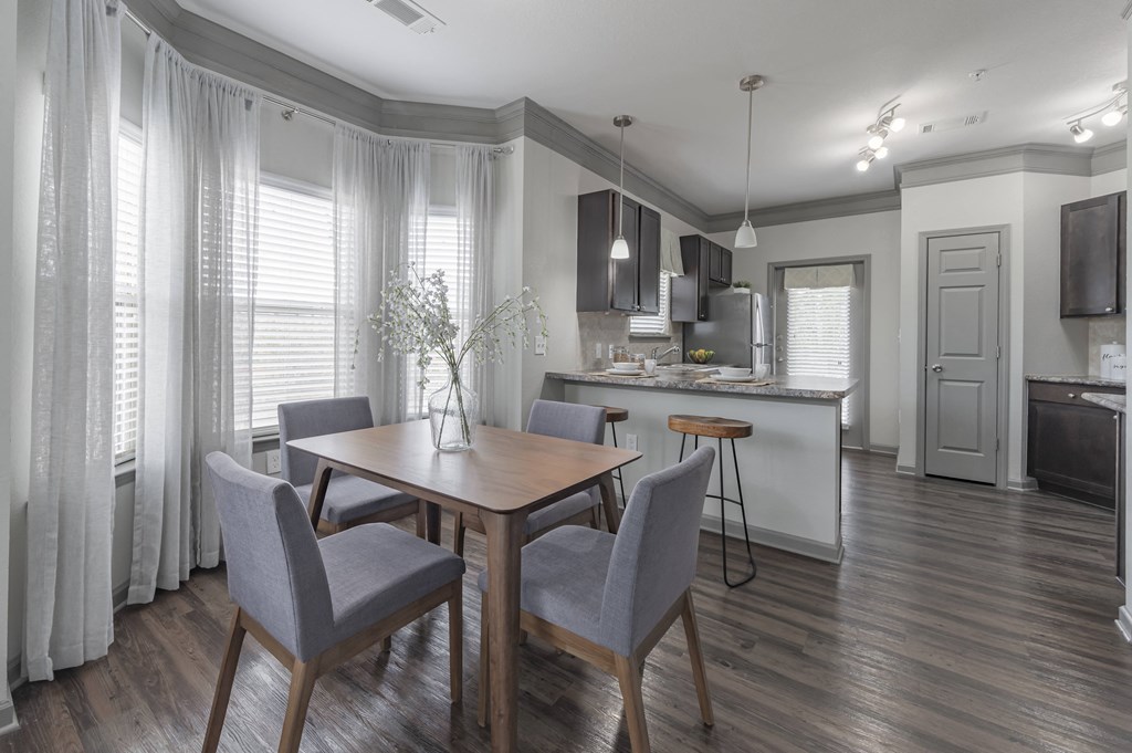 a dining room and kitchen with a table and chairs at Century HomePlace, Alabama