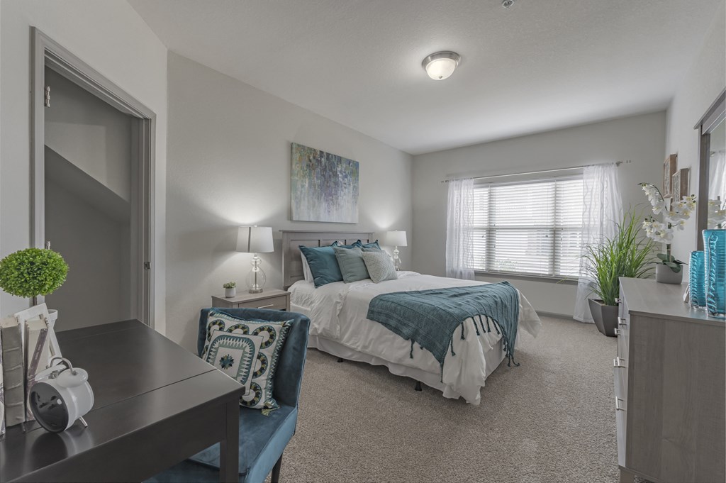 a bedroom with a bed and a desk and a window at Century HomePlace, Prattville, AL