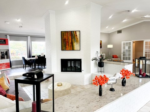 a white living room with a fireplace and a table