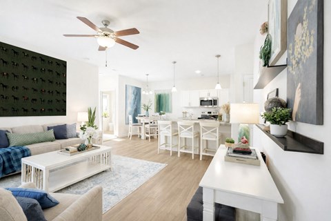 A modern living room with a white sofa and a white coffee table.