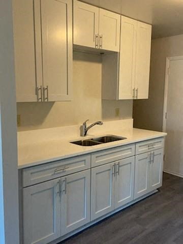 Modern kitchen with white cabinets at The Hideaway at Kinspark apartments Charlotte, NC 28208