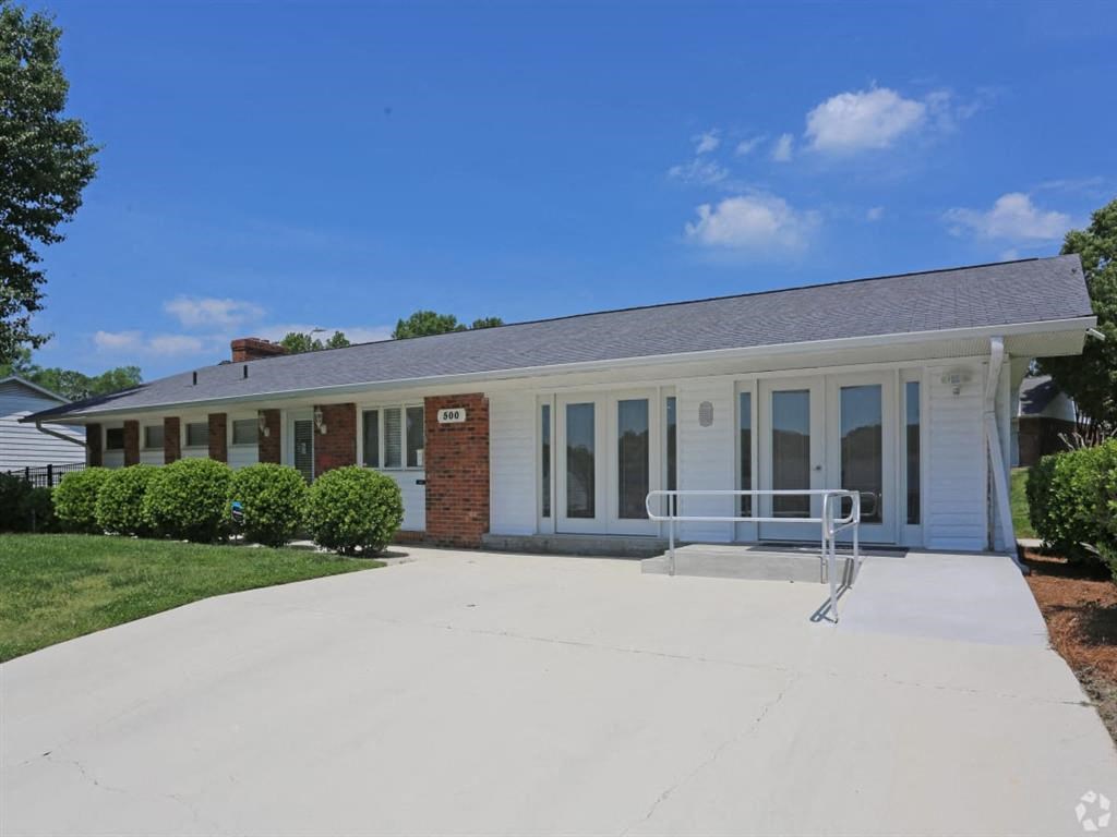 the front of a white house with a concrete driveway at Four Seasons Villas, Greensboro, NC 27406