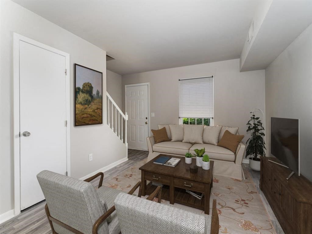 a living room with a couch and a table at Four Seasons Villas, Greensboro, NC