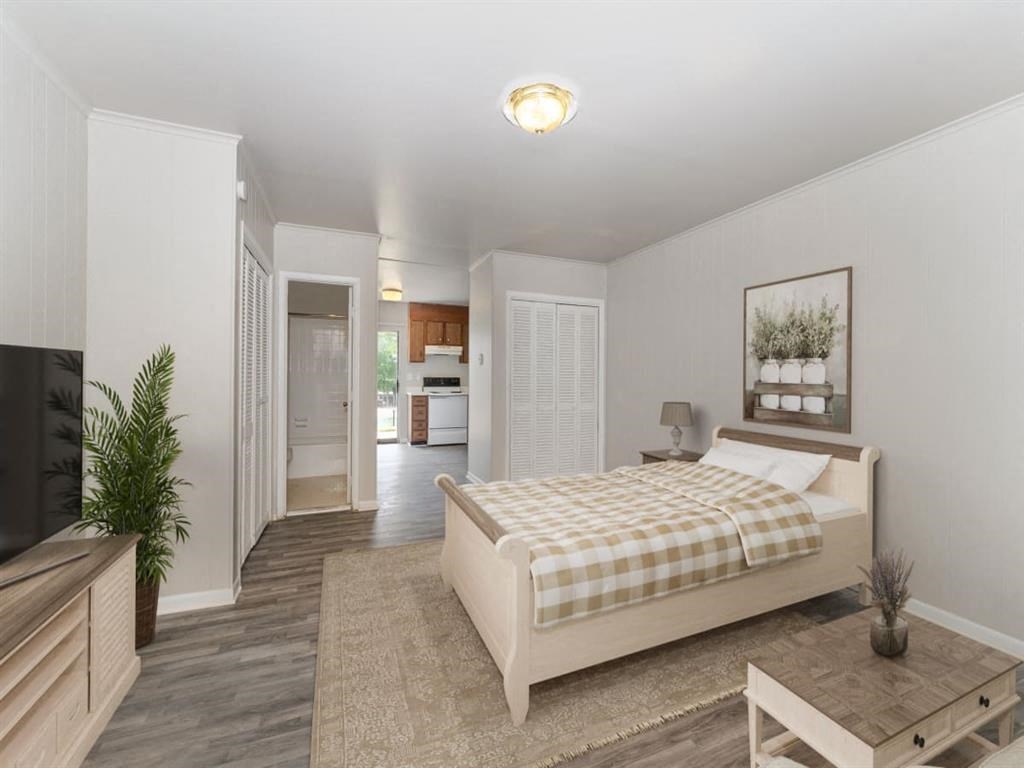 a bedroom with a bed and a tv at Four Seasons Villas, North Carolina