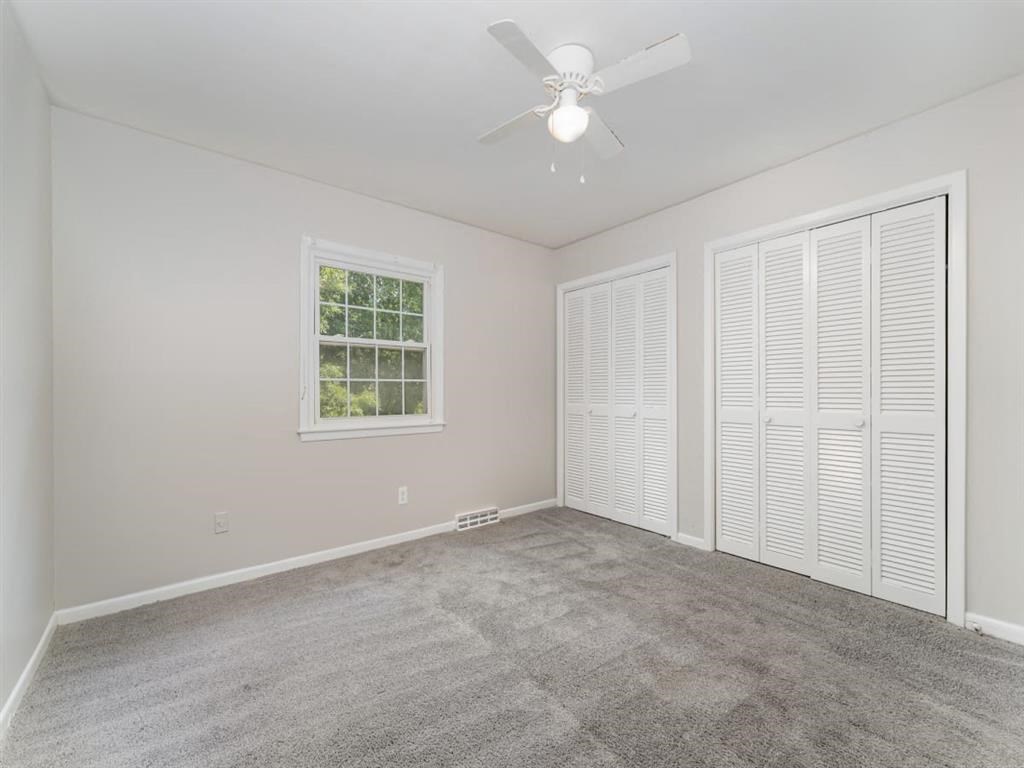 a room with carpet and a ceiling fan at Four Seasons Villas, North Carolina, 27406