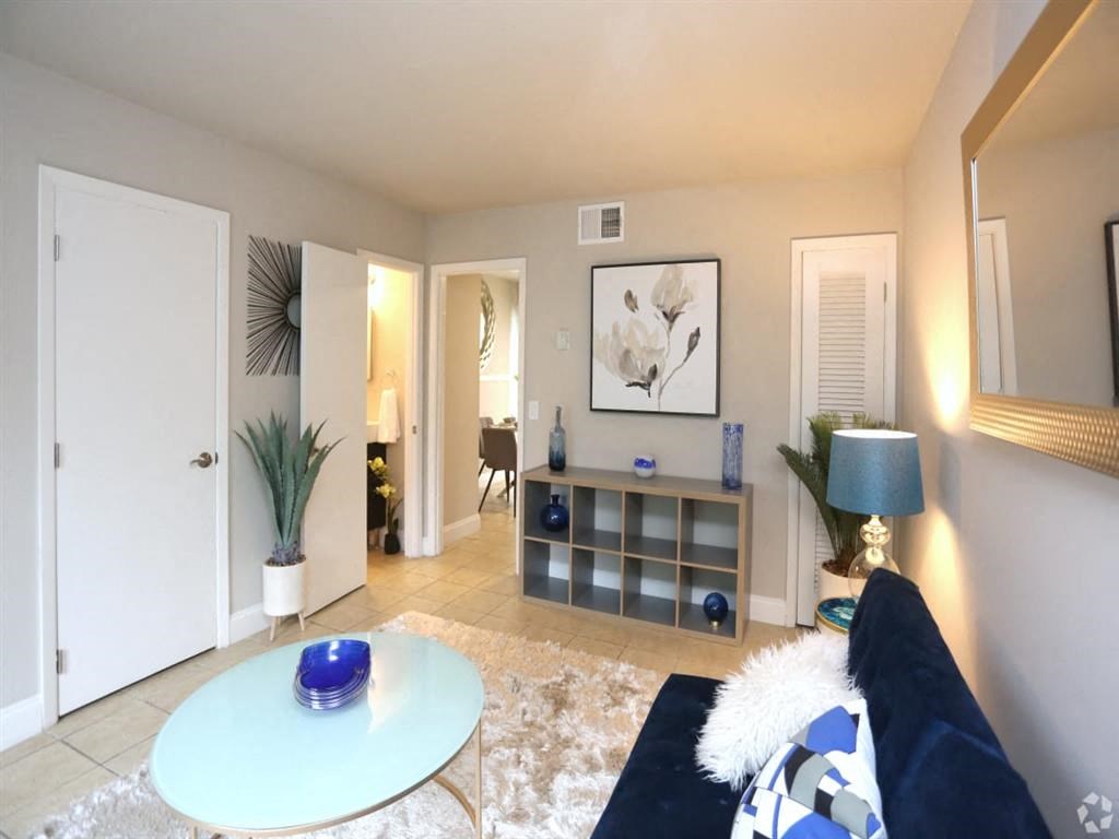 a living room with a couch and a table at Four Seasons Villas, Greensboro, 27406