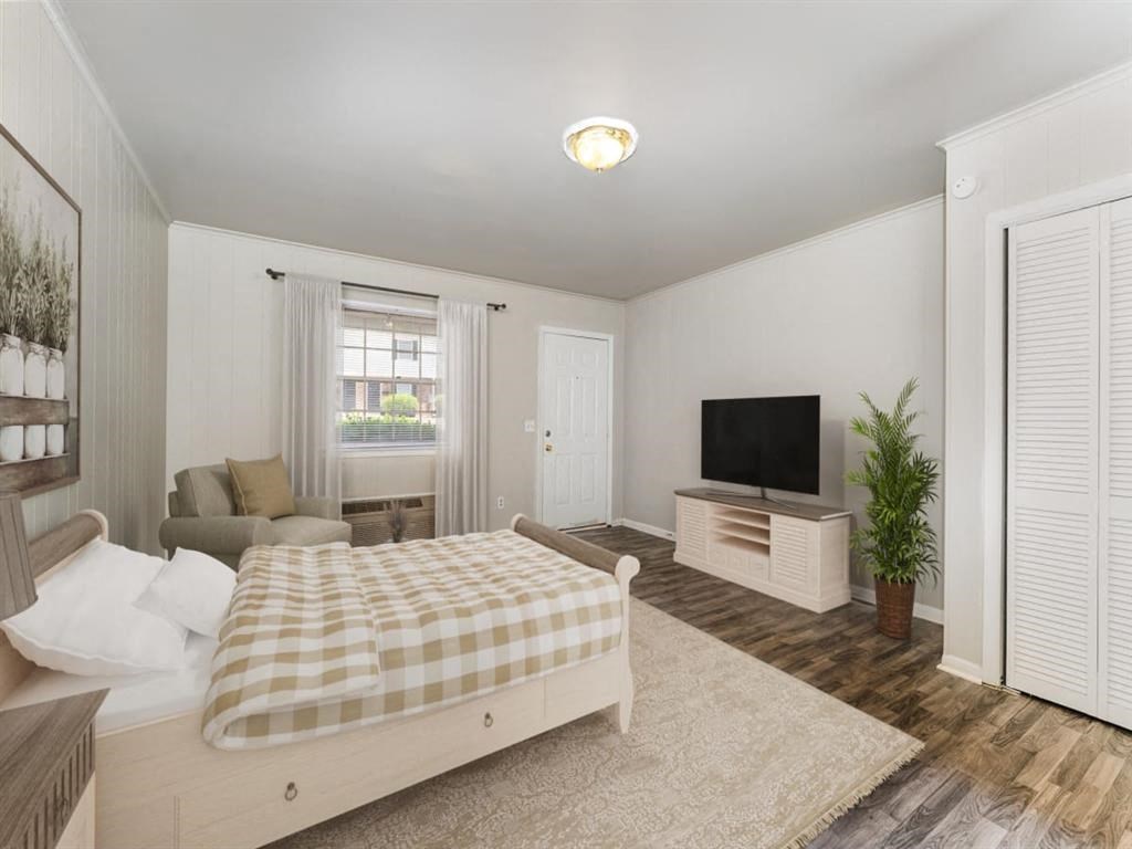 a bedroom with a bed and a tv at Four Seasons Villas, Greensboro, 27406