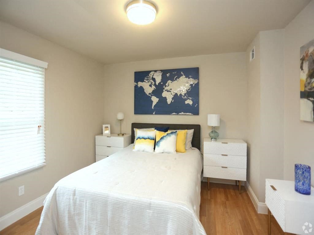 a bedroom with a bed and a map on the wall at Four Seasons Villas, North Carolina