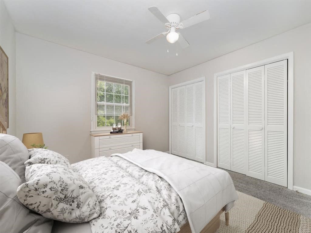 a bedroom with a bed and a ceiling fan at Four Seasons Villas, Greensboro, NC 27406