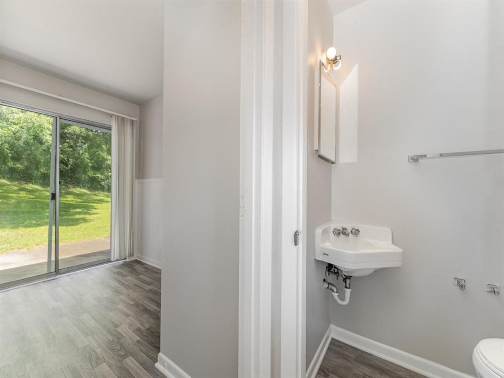 a bathroom with a sink and a window at Four Seasons Villas, Greensboro, 27406