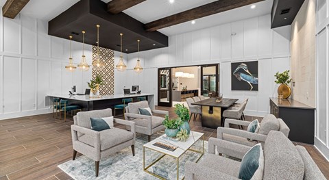 A modern living room with a grey sofa, a coffee table, and a dining table set up.