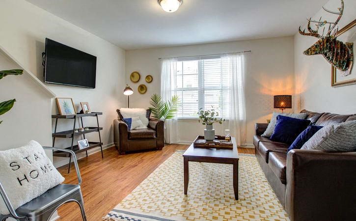 Living room with hardwood floors at Oasis at Cedar Branch in Wilmington, NC