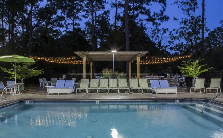 Pool at nighttime at Oasis at Twinwood in Wilmington, NC