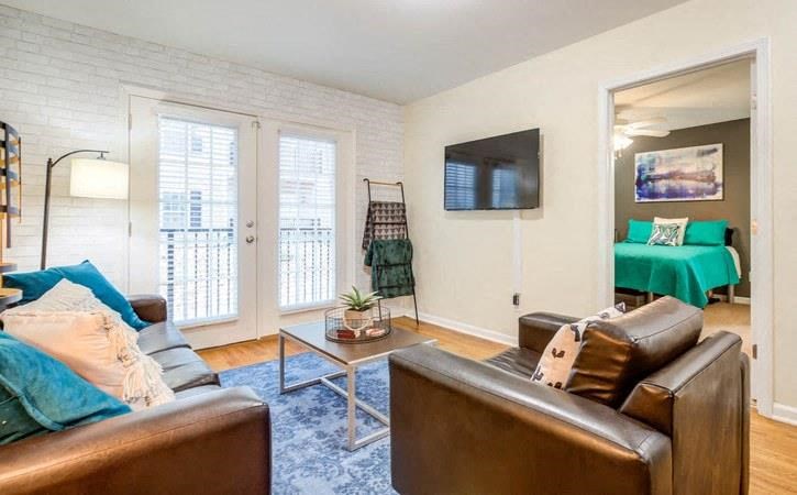 Living room with patio doors at Oasis at Twinwood in Wilmington, NC