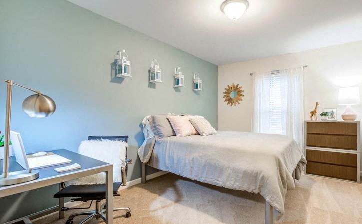 Bedroom with accent wall at Oasis at Twinwood in Wilmington, NC