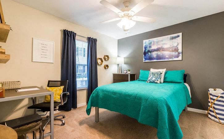 Bedroom with ceiling fan at Oasis at Twinwood in Wilmington, NC