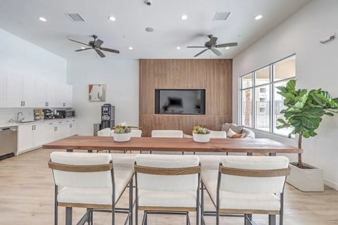 A modern dining room with a wooden table and chairs.