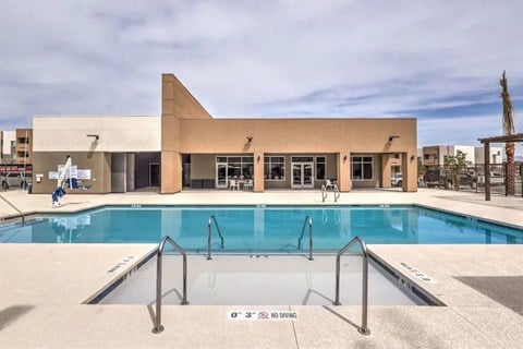A swimming pool with a building in the background.