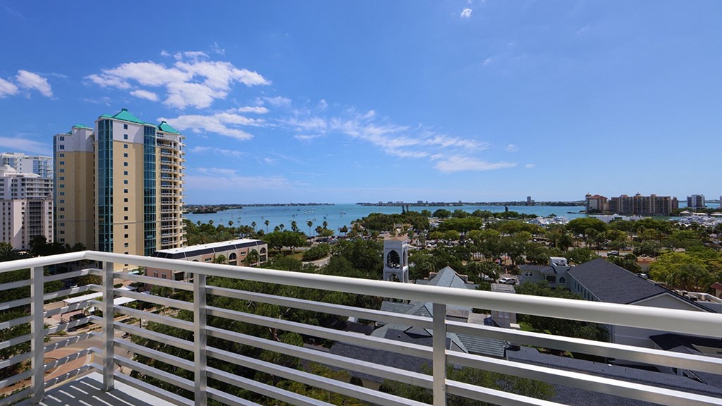 a view of the water from the balcony of a condo