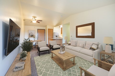 A living room with a couch, chairs, and a coffee table.
