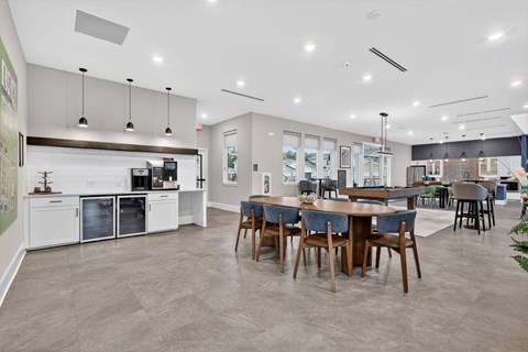 A modern kitchen with a dining table and chairs.