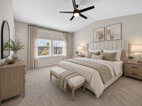 A bedroom with a large bed, a bench, and a ceiling fan.