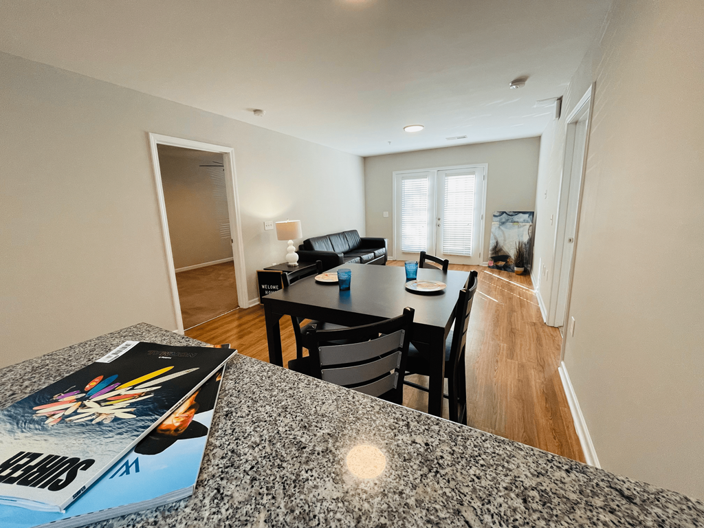 Kitchen bar overlooking dining space at Oasis at Cedar Branch in Wilmington, NC