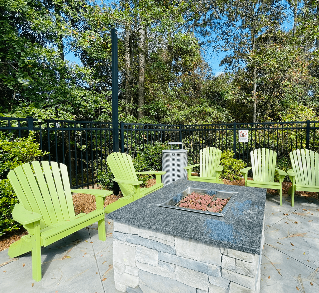 Fire pit with lounge chairs at Oasis at Twinwood in Wilmington, NC
