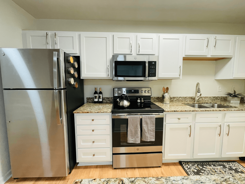 Kitchen with white shaker cabinets at Oasis at Twinwood in Wilmington, NC