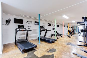 a gym with treadmills and other exercise equipment  at The Oasis on Cascade, Atlanta, GA