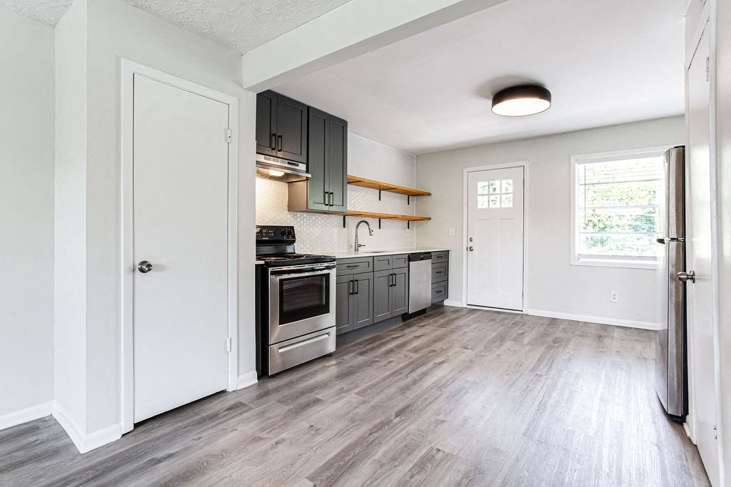 a kitchen with gray cabinets and stainless steel appliances  at The Oasis on Cascade, Atlanta, GA, 30310