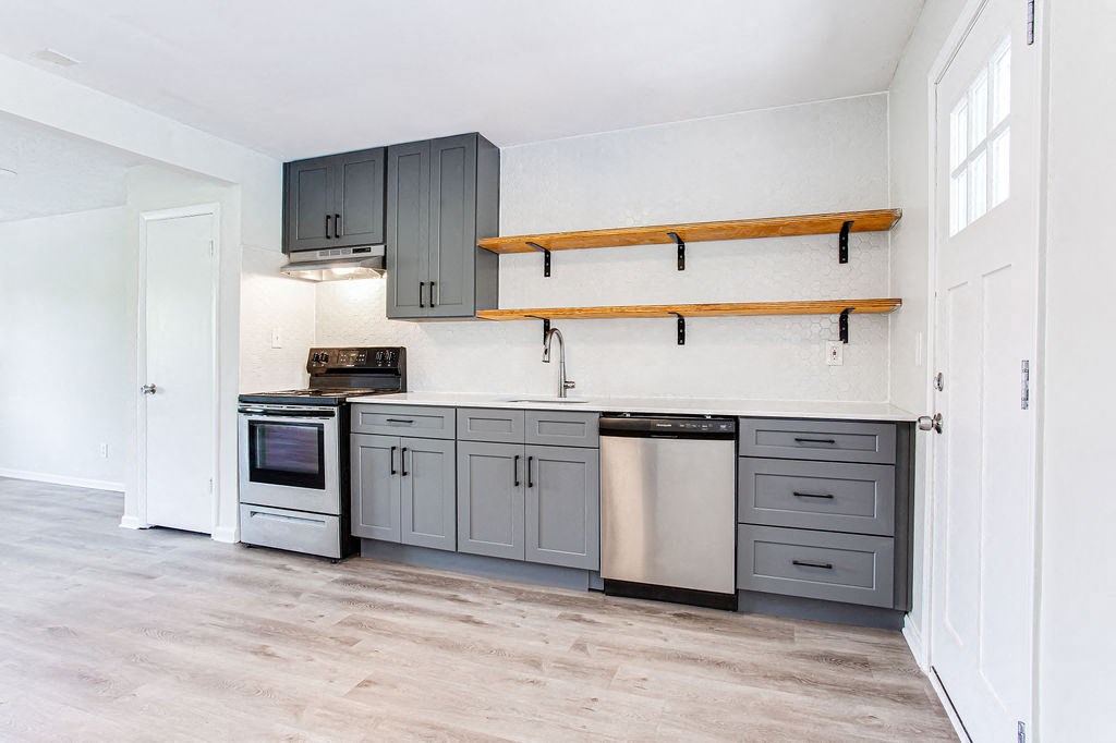 a kitchen with gray cabinets and white walls  at The Oasis on Cascade, Atlanta, Georgia
