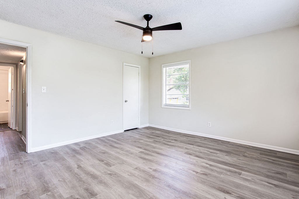 an empty bedroom with a ceiling fan  at The Oasis on Cascade, Atlanta