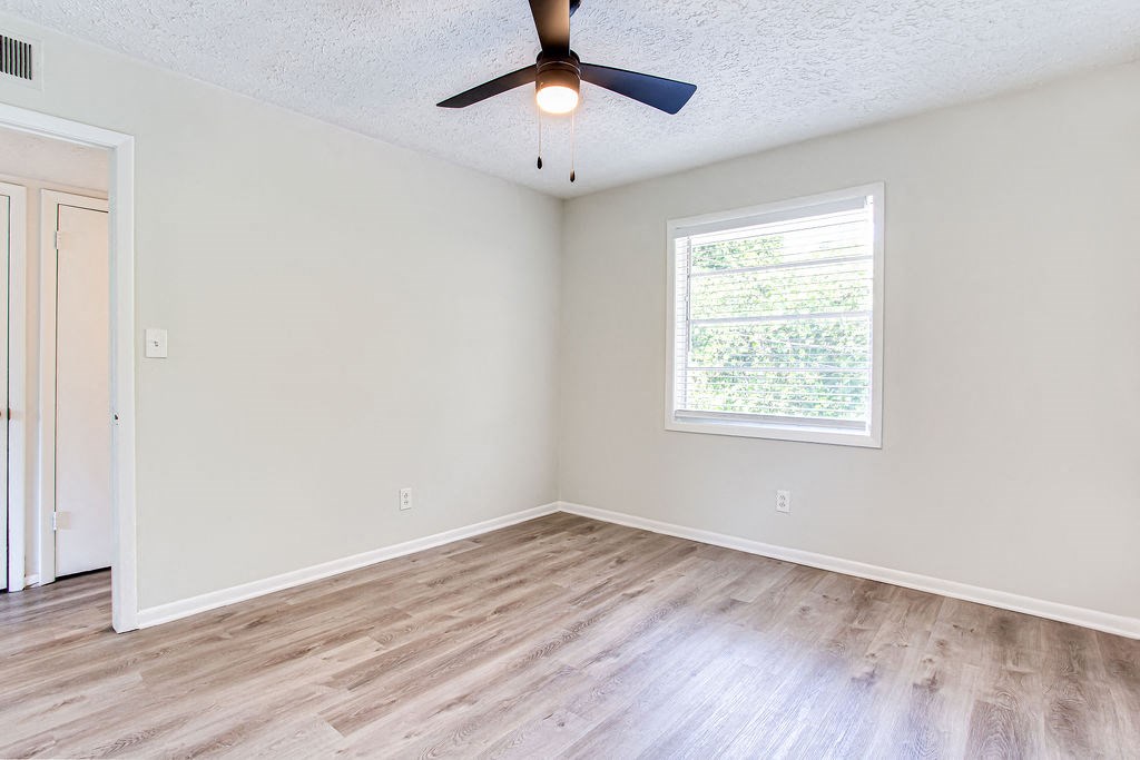 an empty room with a ceiling fan and a window  at The Oasis on Cascade, Atlanta, 30310