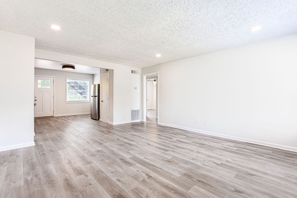a bedroom with hardwood floors and white walls  at The Oasis on Cascade, Atlanta, GA