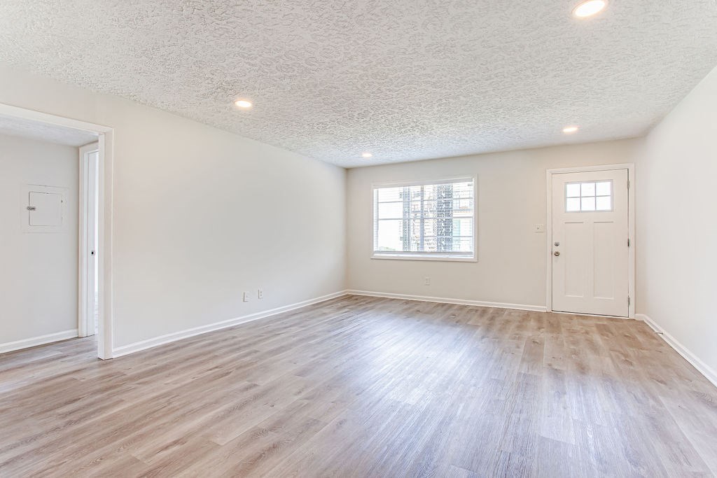 a bedroom with hardwood floors and white walls  at The Oasis on Cascade, Georgia