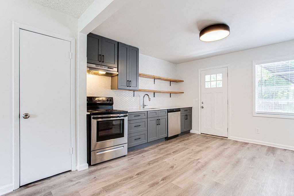a kitchen with gray cabinets and stainless steel appliances  at The Oasis on Cascade, Atlanta, 30310